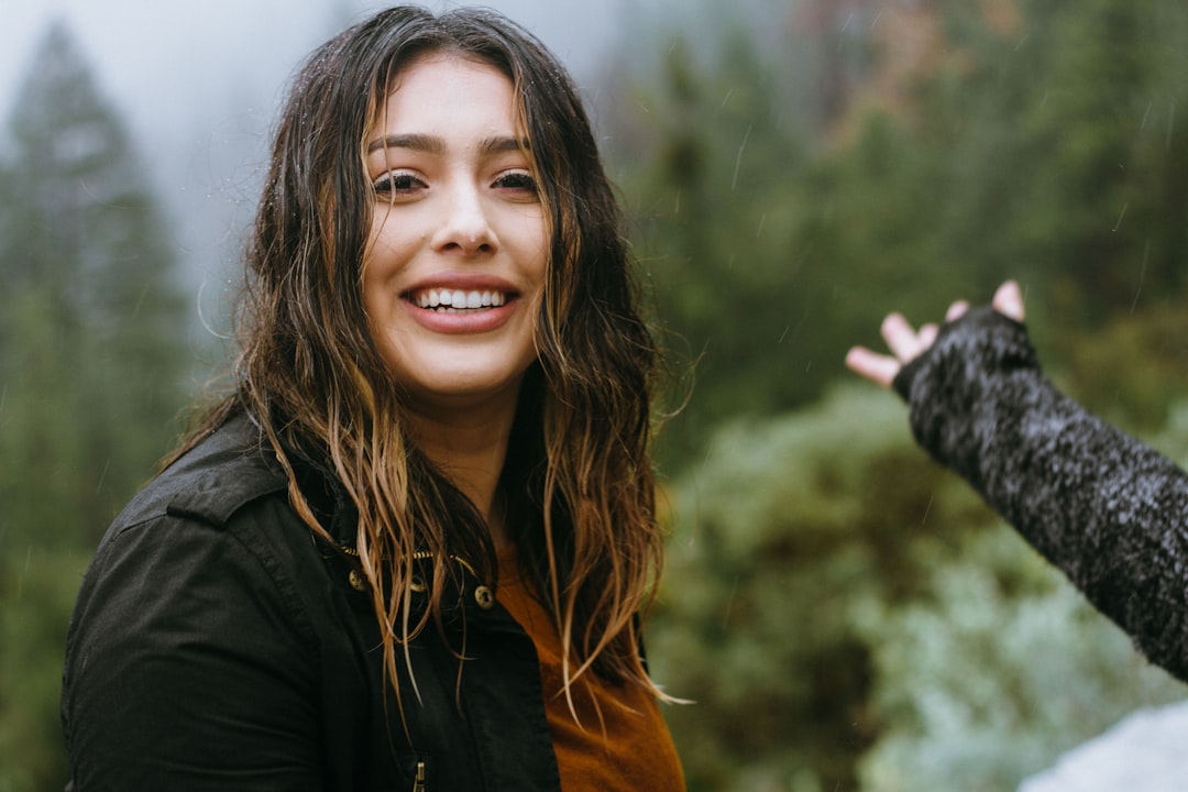 Why do we celebrate the Hispanic month? by Hispanic Month woman wearing black jacket smiling with forest background