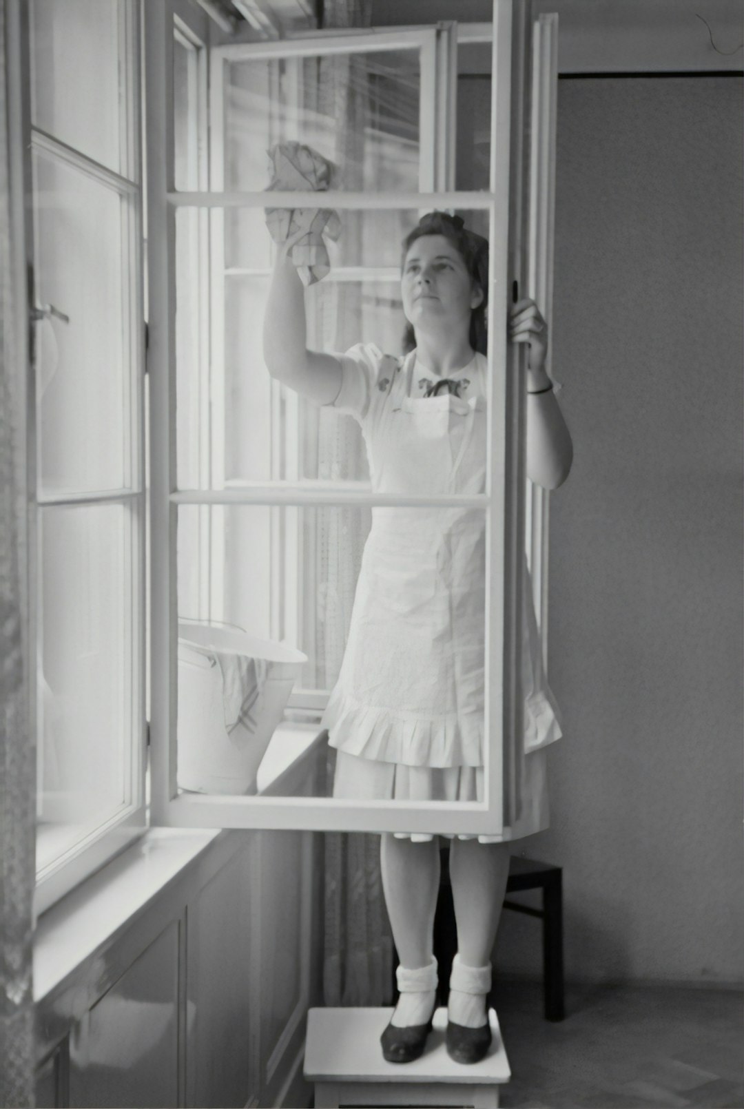 When cleaning windows, 1943 by Hispanic Month grayscale photography of woman cleaning glass window