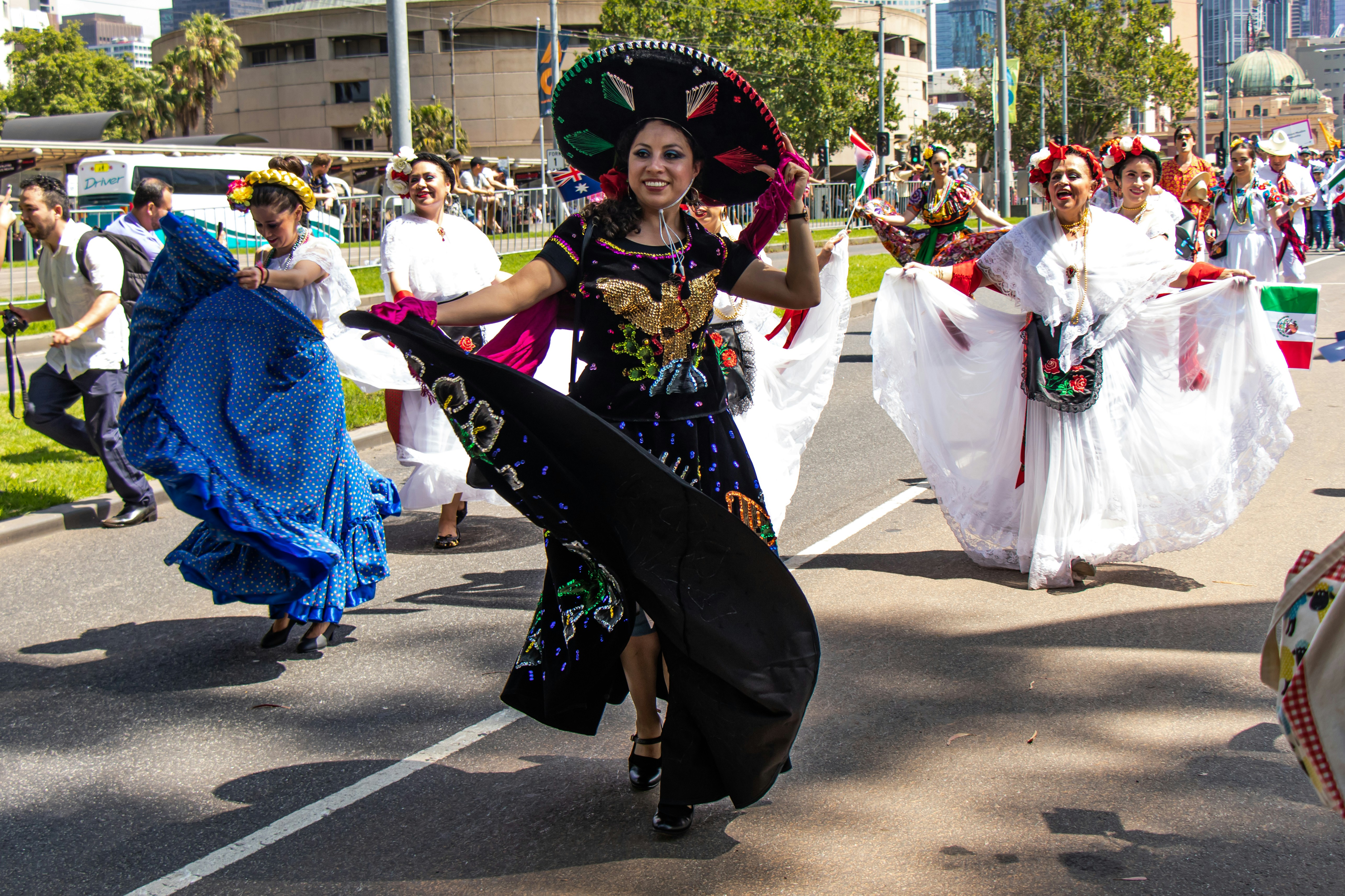 Australia Day Parade by Hispanic Month woman in black and white dress wearing black hat