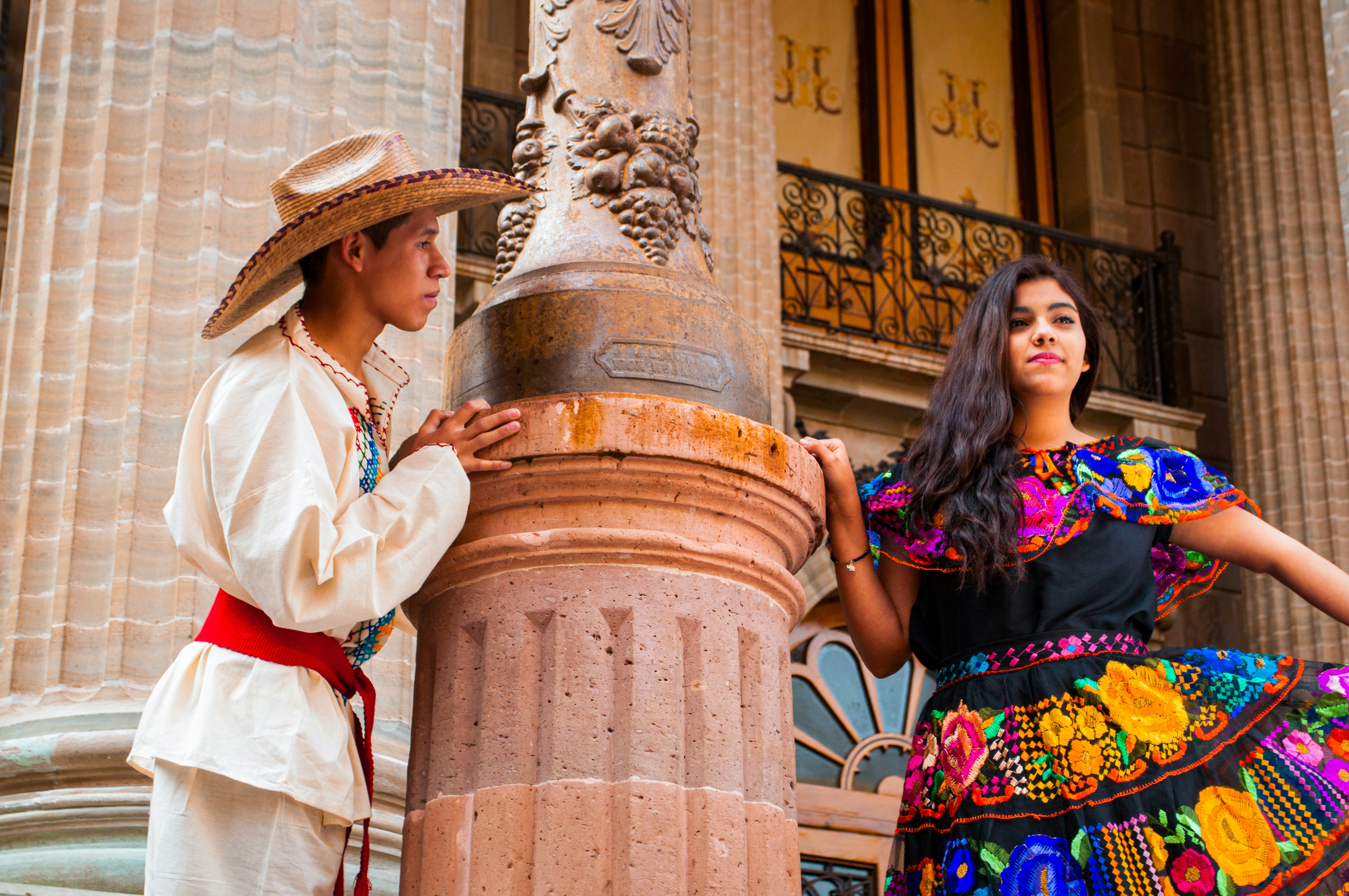 man and woman standing beside pillars