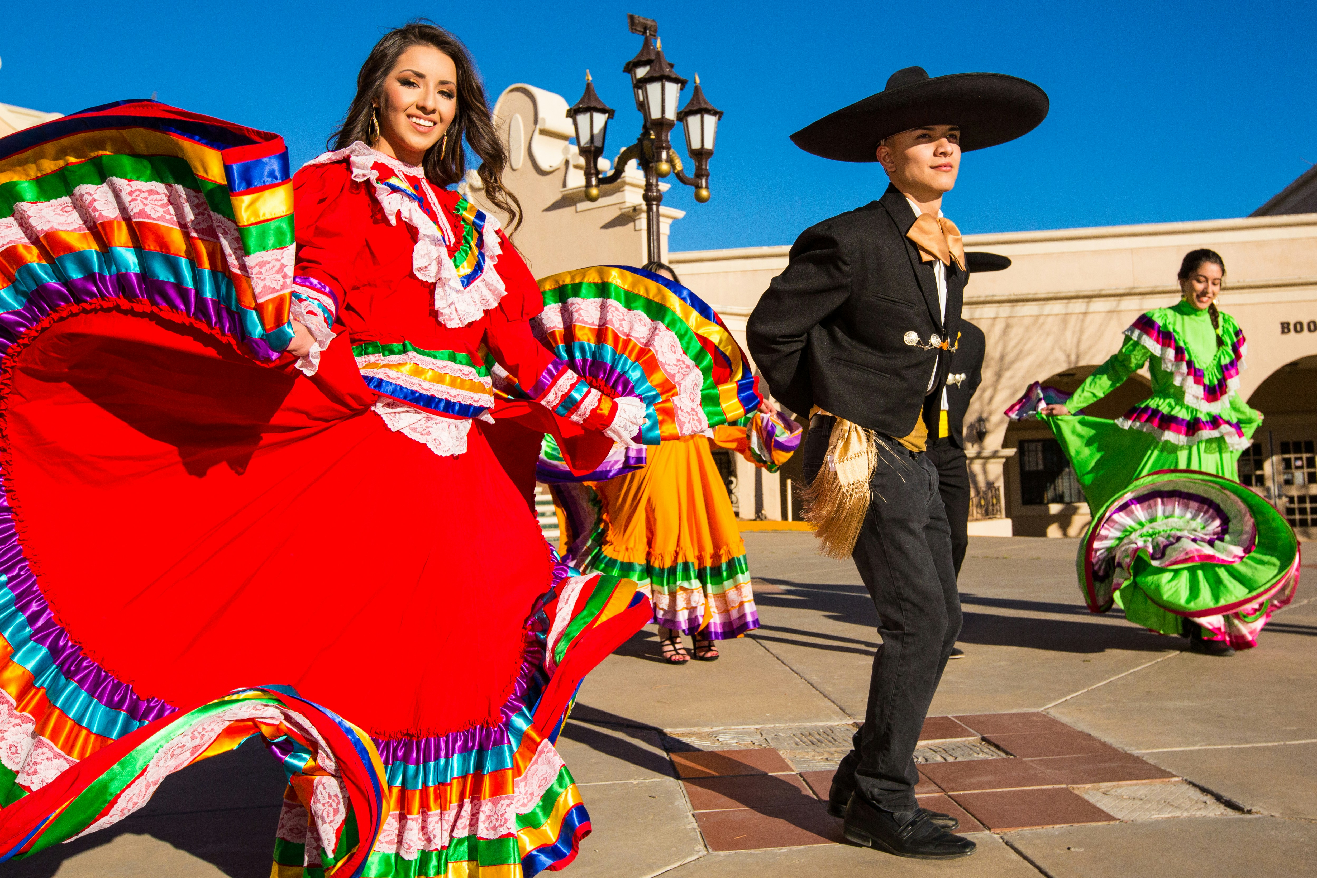 woman in red and yellow dress wearing black hat