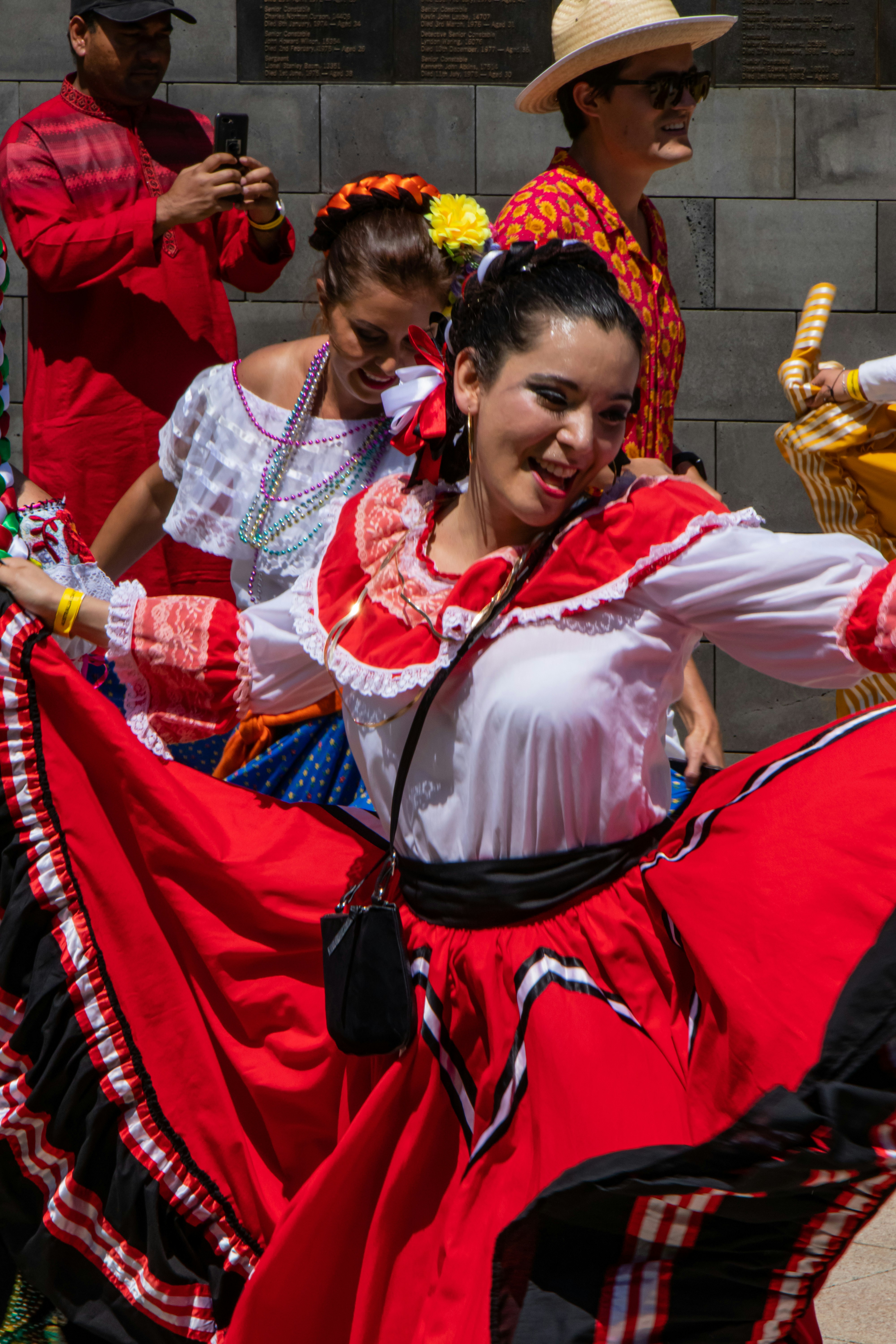 Australia Day Parade by Hispanic Month woman in white and red dress sitting on red chair