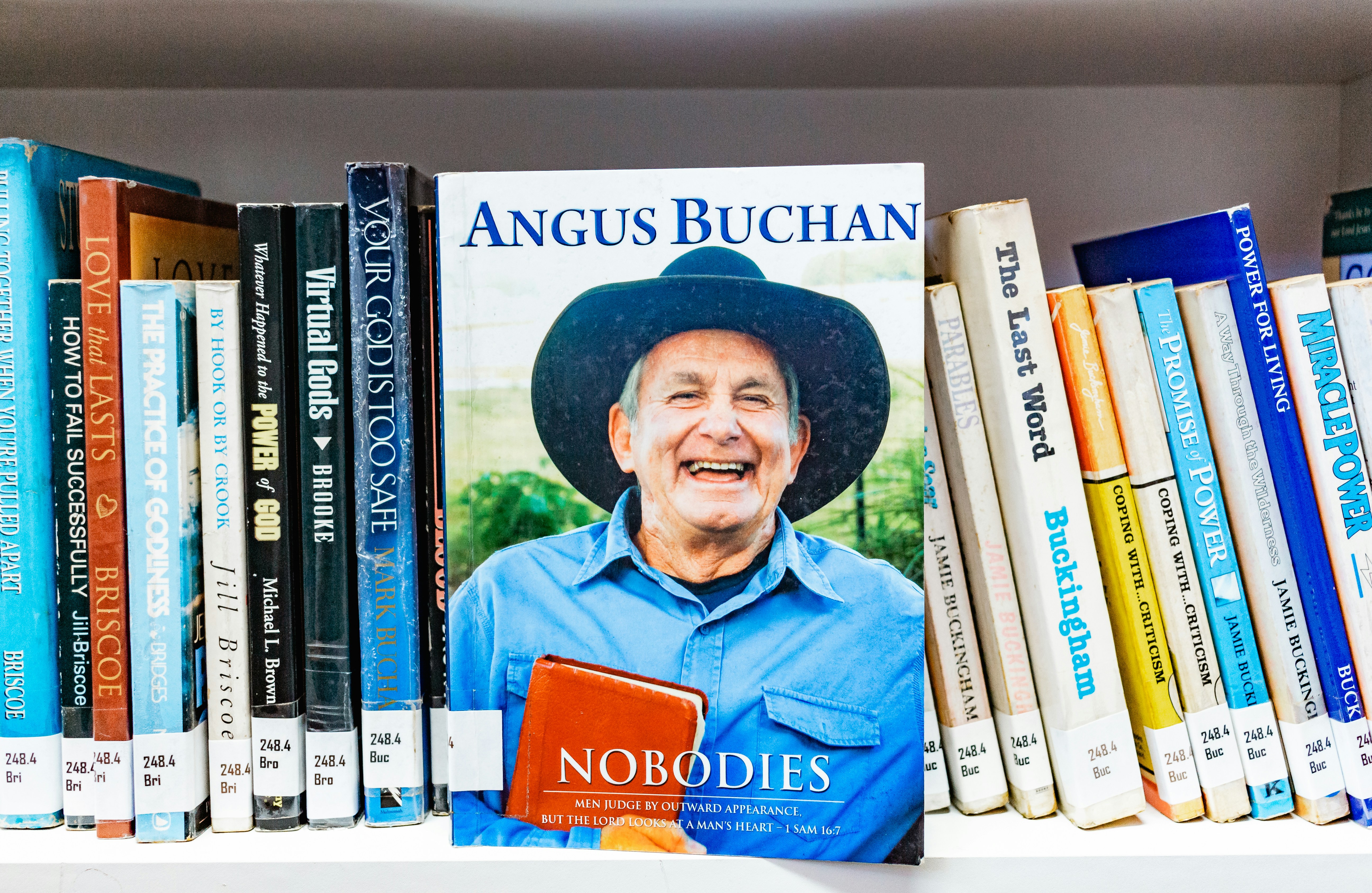 man in blue polo shirt wearing black hat